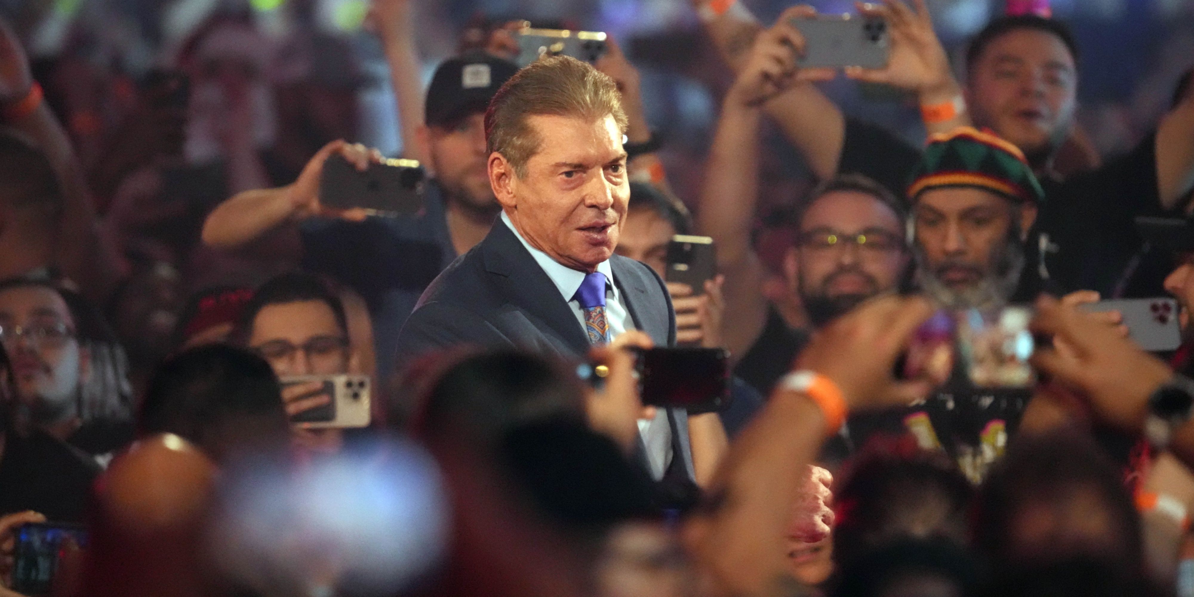 vince mcmahon in a crowd of wwe fans.