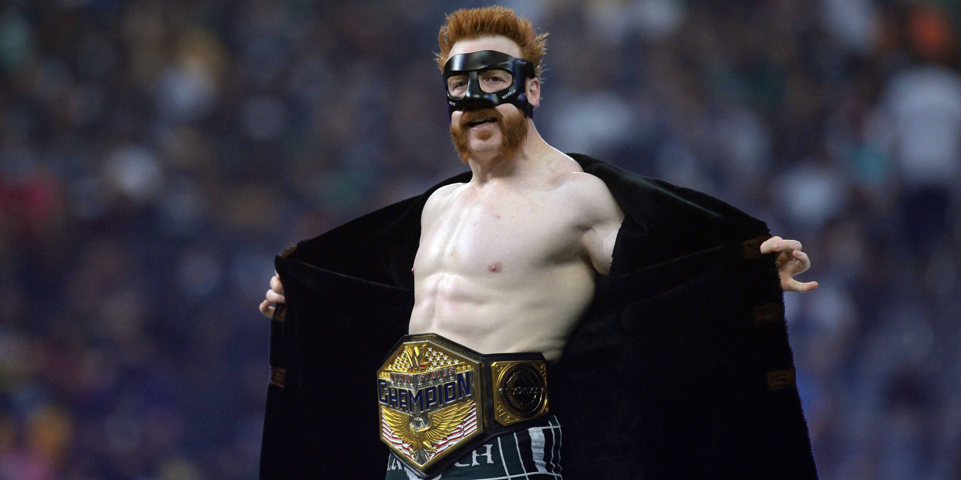 sheamus opening his coat to reveal the us title.