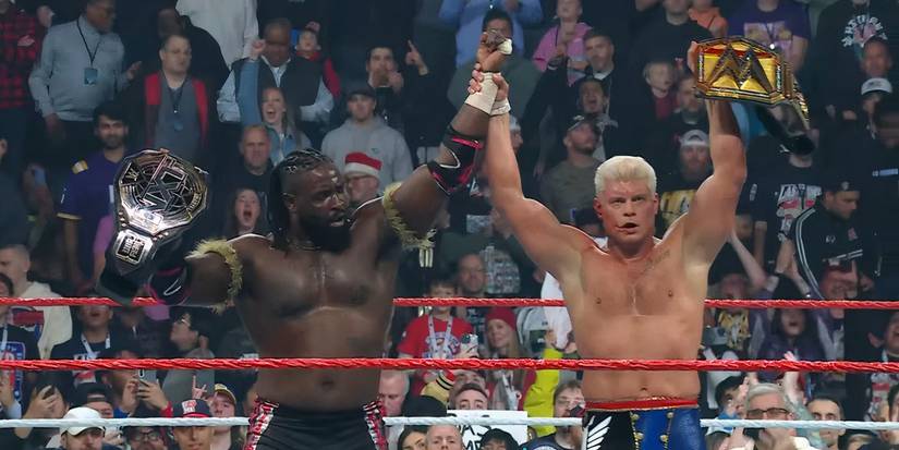 Oba Femi and Cody Rhodes with their hands raised