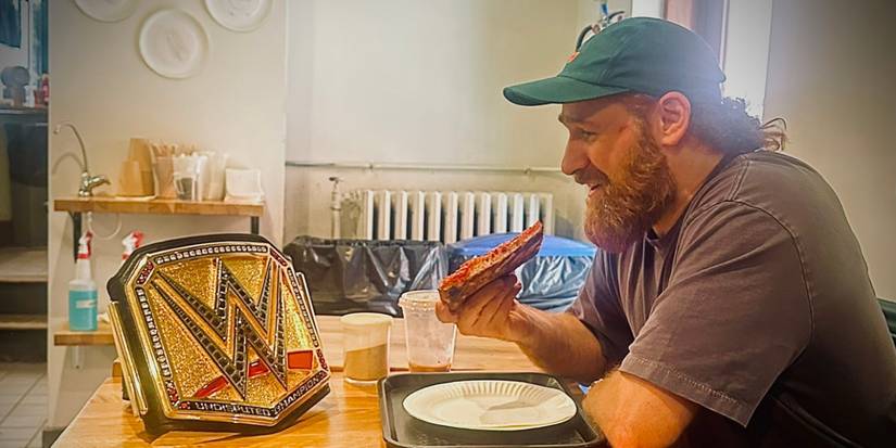 Sami Zayn having dinner with the WWE Championship