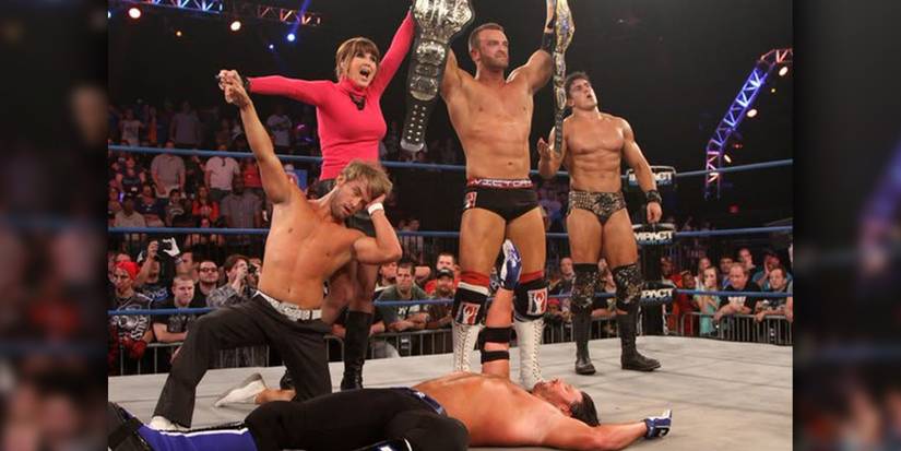 Magnus, as the Unified TNA World Champion, stands over AJ Styles